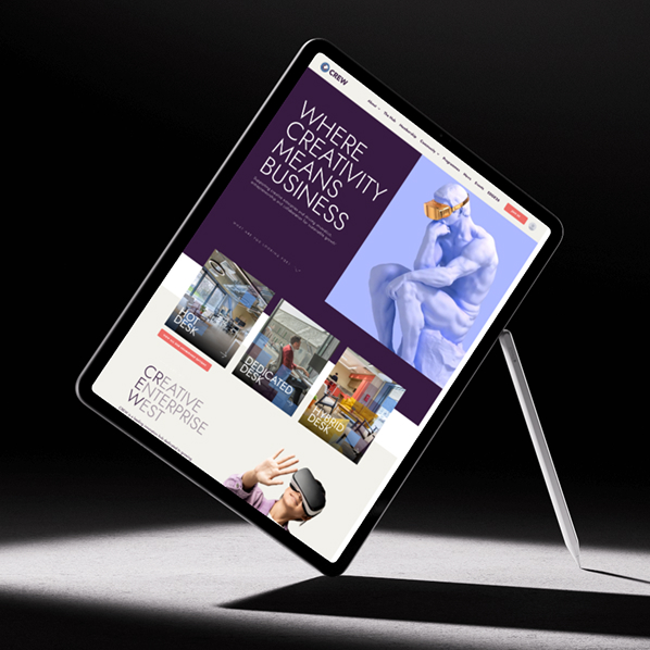 A tablet floating at an angle displays a creative business website built with Simpl by Rob&Paul, featuring bold text, images of people, and a blue statue, all set against a dark, minimalist background.
