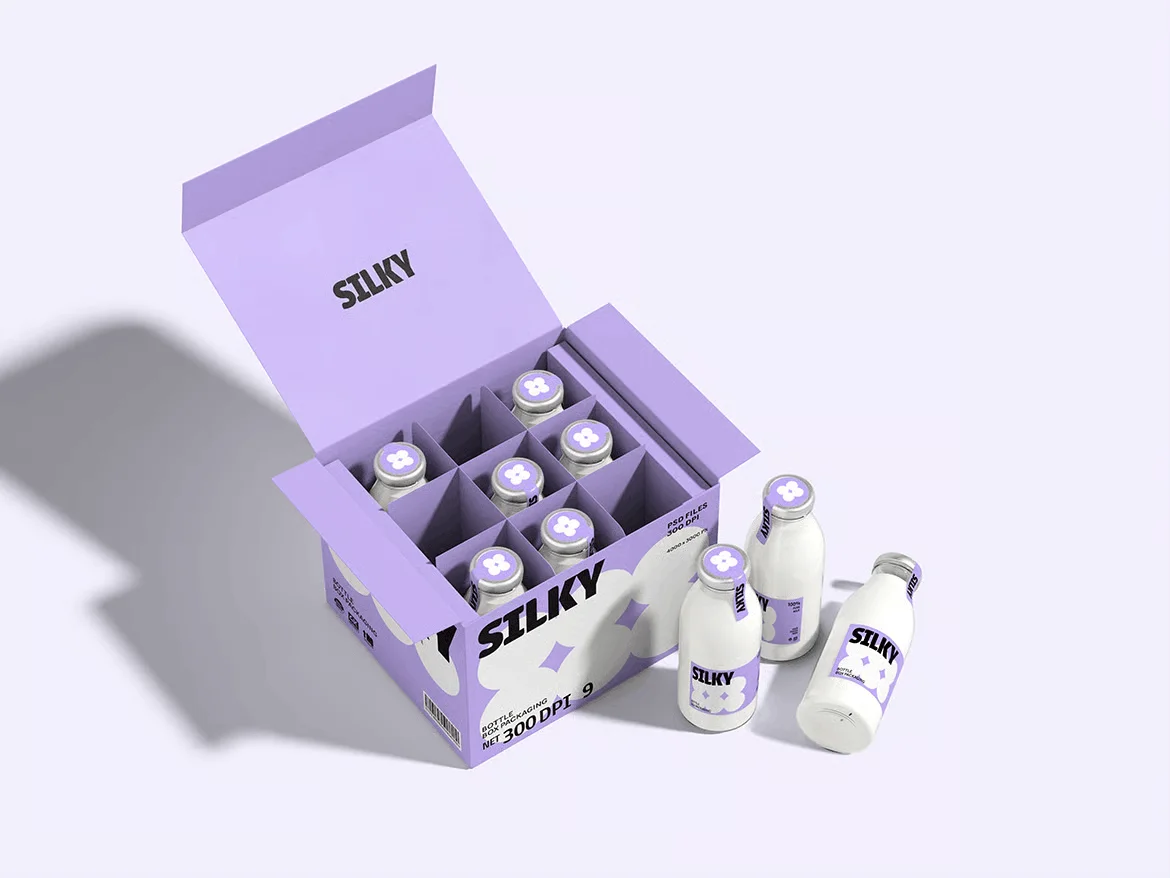 An open lavender-colored box labeled SILKY by Simpl by Rob&Paul holds nine glass bottles with white liquid and purple caps. Three bottles are outside the box, set against a light lavender background.