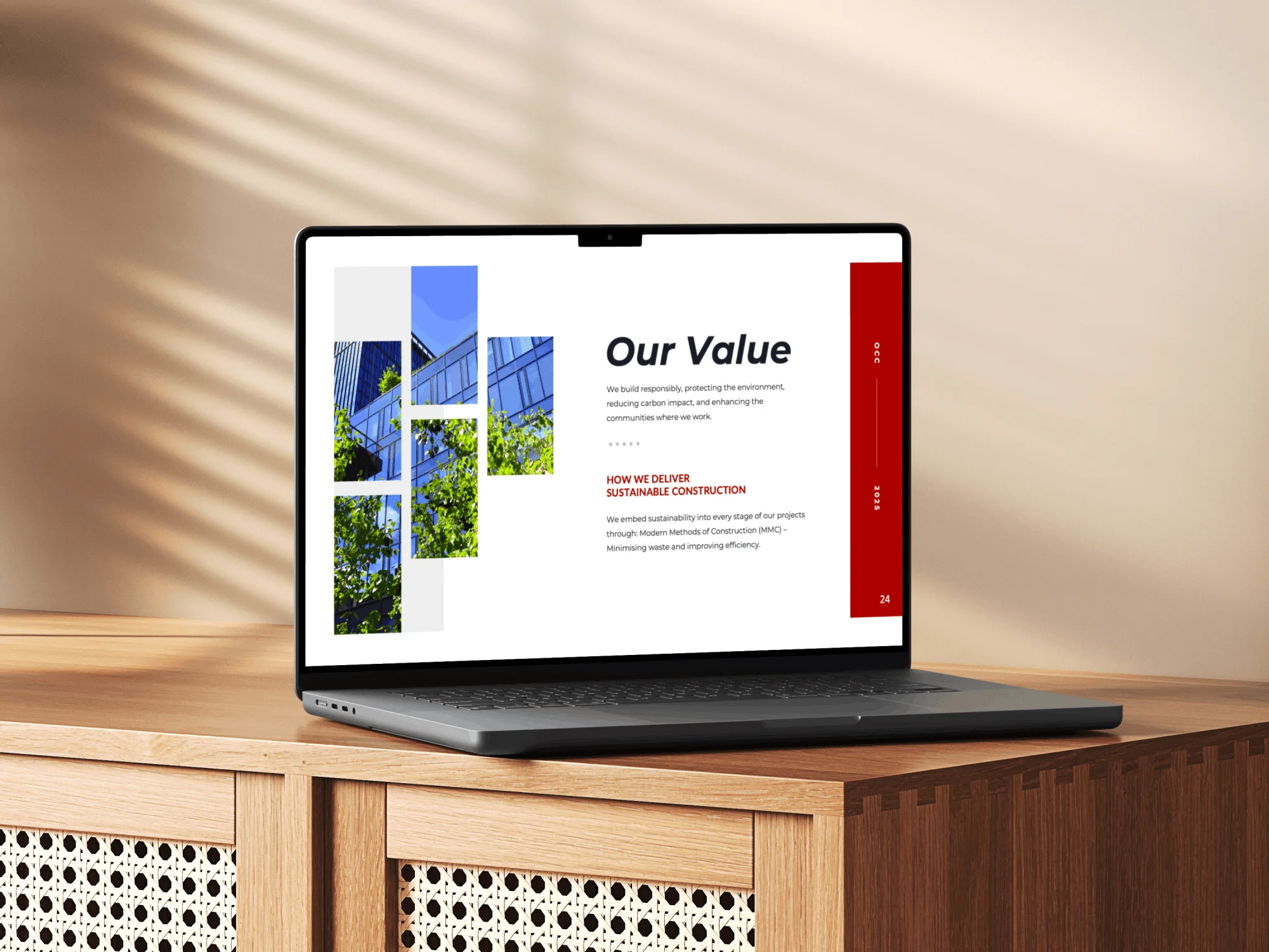 A laptop on a wooden cabinet displays a presentation slide titled Our Value, featuring images of a modern building with green trees and text about sustainable construction using Simpl by Rob&Paul. Sunlight casts patterns on the wall in the background.