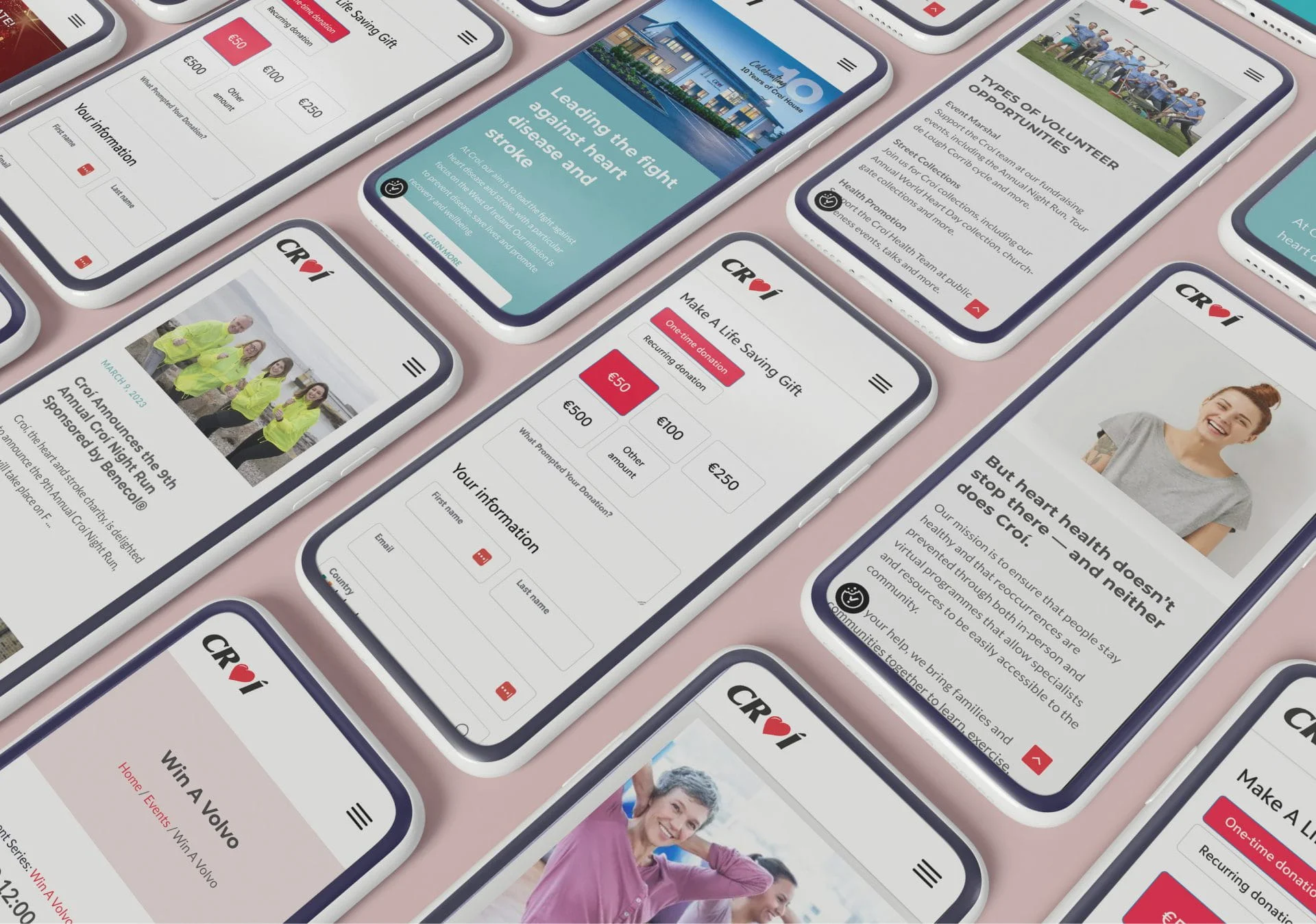 A collection of smartphones on a pink surface, each showcasing Simpl by Rob&Paul charity or nonprofit mobile websites, featuring donation forms, inspiring stories, images of people, and calls to action.