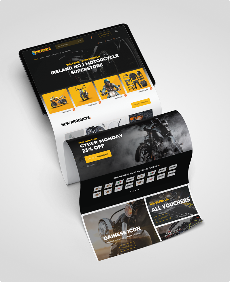 A digital tablet and two printed sheets display a motorcycle superstore website designed with Simpl by Rob&Paul, showcasing bikes, gear, a 25% off Cyber Monday sale, featured brands, and discount vouchers on a white background.