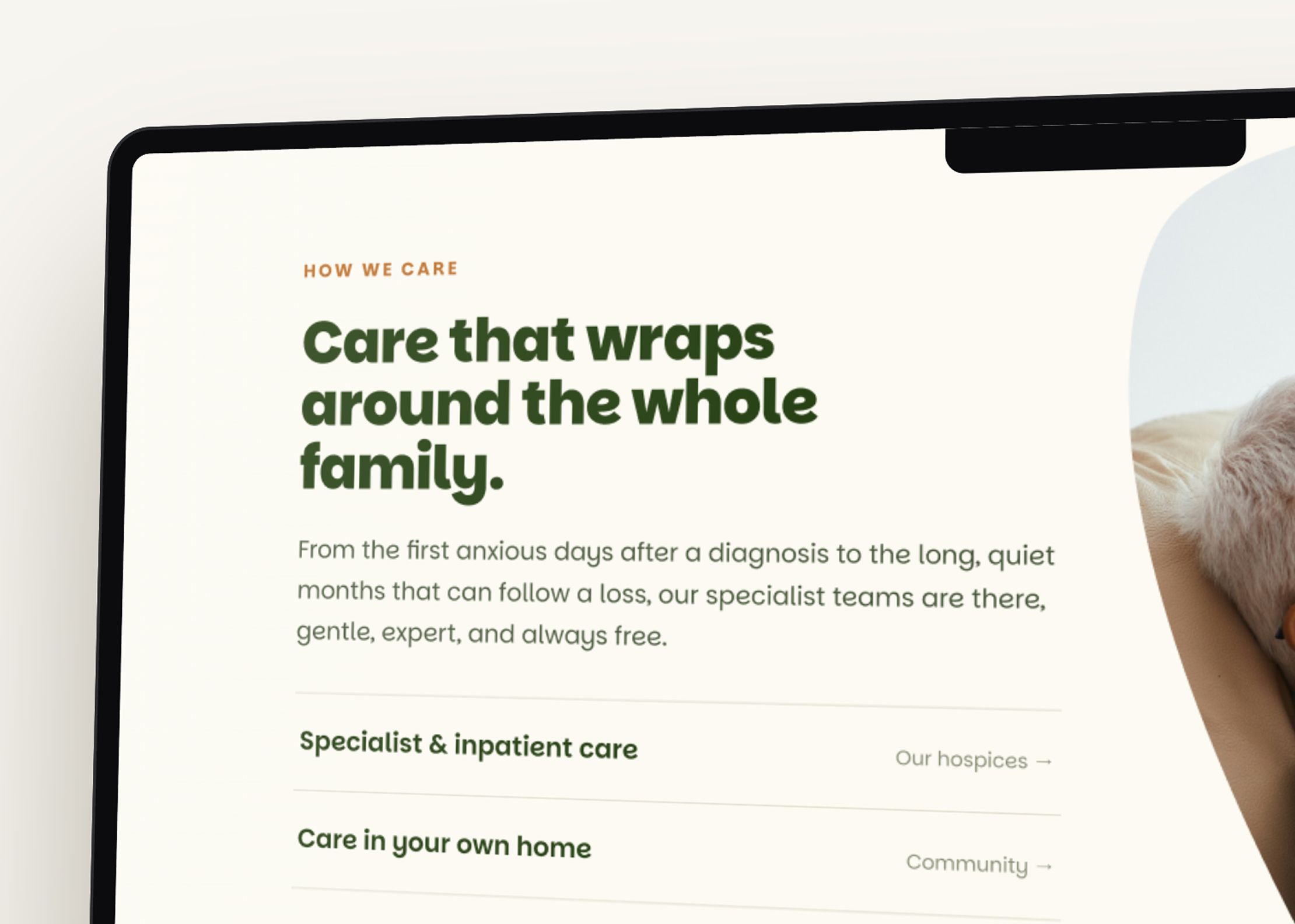 A computer screen displays a website section titled Care that wraps around the whole family, describing specialist team support from Mayo Roscommon Hospice Foundation for families after a diagnosis or loss.