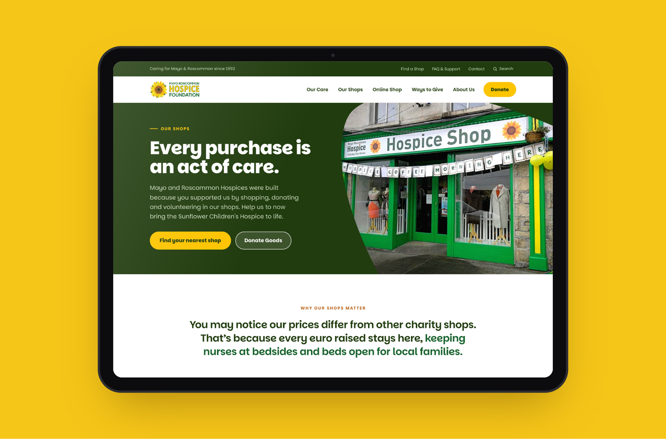 A tablet displays a hospice shop website with a green and yellow theme, featuring a photo of the shop’s entrance, donation information, and a statement about supporting local hospice care through the Mayo Roscommon Hospice Foundation.